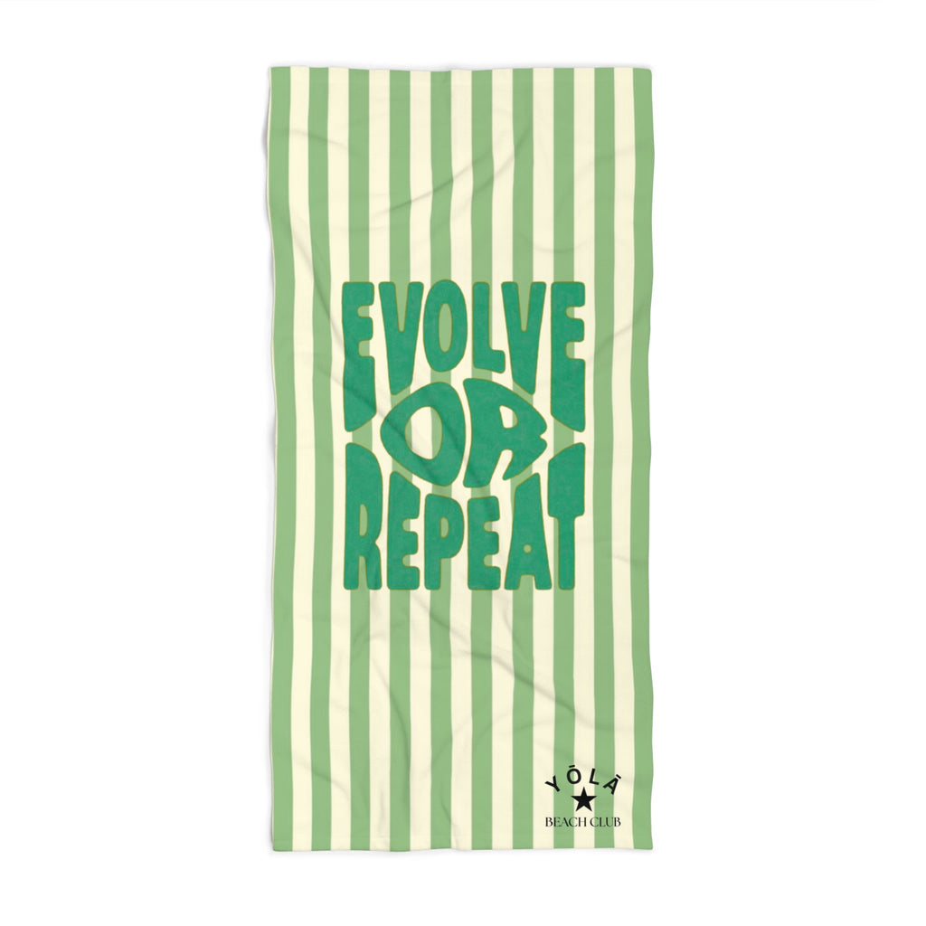 Green and white striped towel with 'Evolve Love Repeat' text on a white background