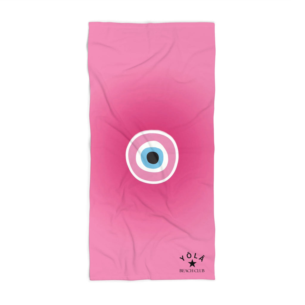 Pink towel with a circular design and 'Yola' branding on a white background