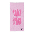 Pink towel with 'Take Up Space' text on a white background