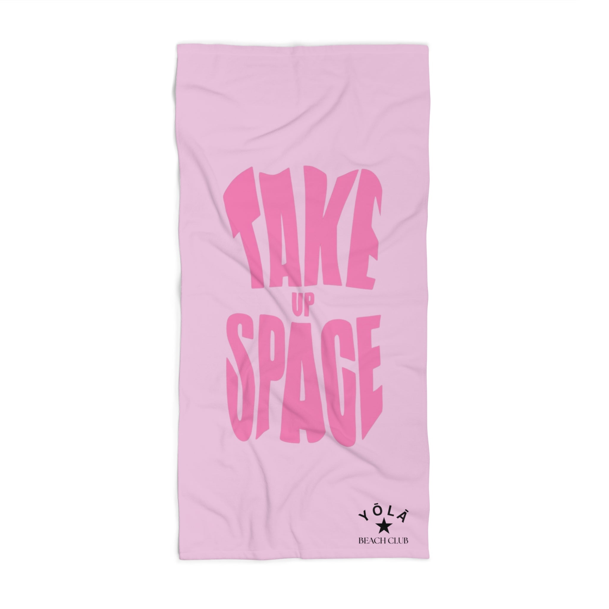 Pink towel with 'Take Up Space' text on a white background