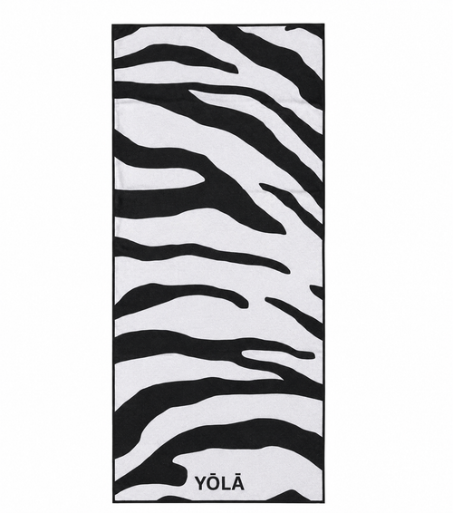 YŌLĀ SCULP'T Zebra Grip Towel featuring a black and white zebra print, made from premium microfiber suede with a non-slip silicone dot backing for hot Pilates and yoga.