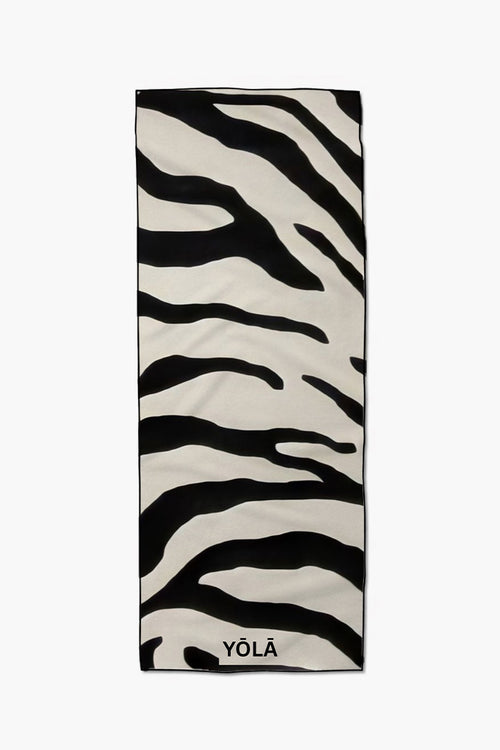 Black and white zebra-print yoga mat towel with abstract stripes, laid flat vertically by YOLA
