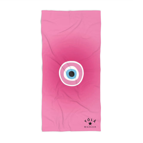 Pink towel with a circular design and 'Yola' branding on a white background