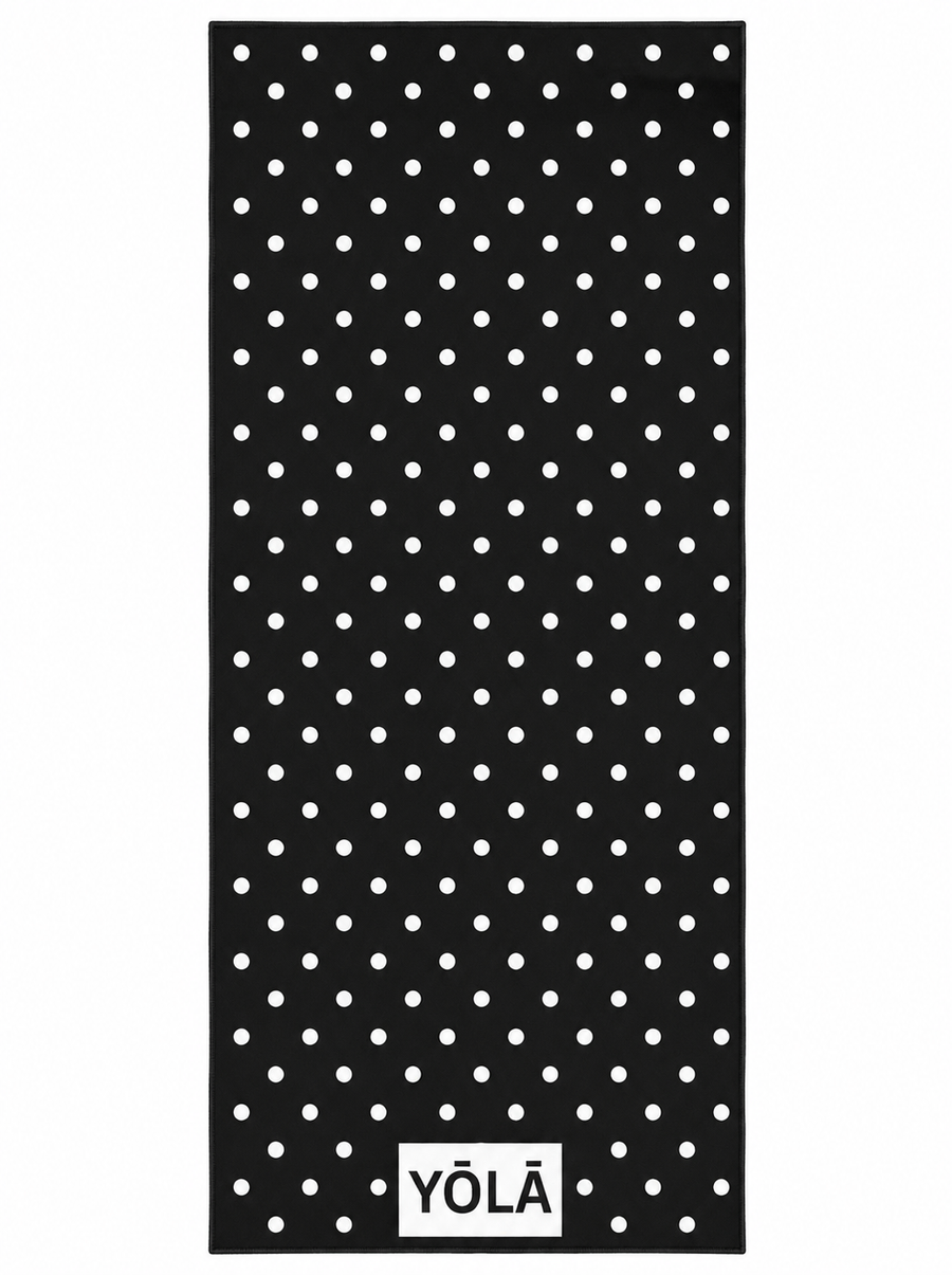 YŌLĀ SCULP'T Reverse Polka Grip Towel with a black and white polka dot print, premium microfiber suede, sweat-activated grip, and non-slip silicone dot backing for hot Pilates, hot yoga, and studio workouts.