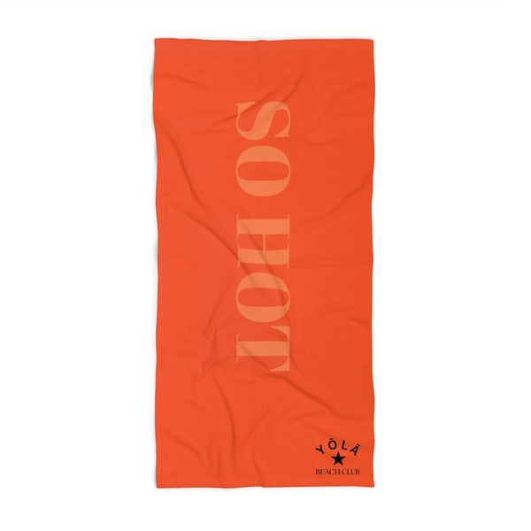 Orange towel with 'SO HOT' text and a brand logo on a white background